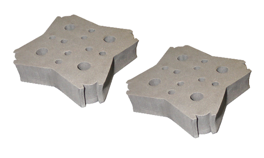 Two gray metal blocks with circular holes on a white background