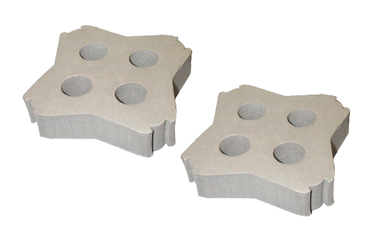 Two concrete pavers with circular holes on a white background