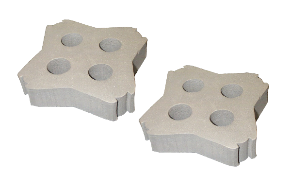Two concrete pavers with circular holes on a white background