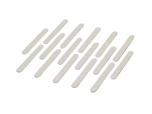 Set of white nail files arranged in a pattern on a white background