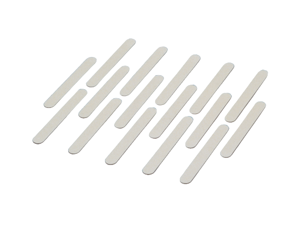 Set of white nail files arranged in a pattern on a white background