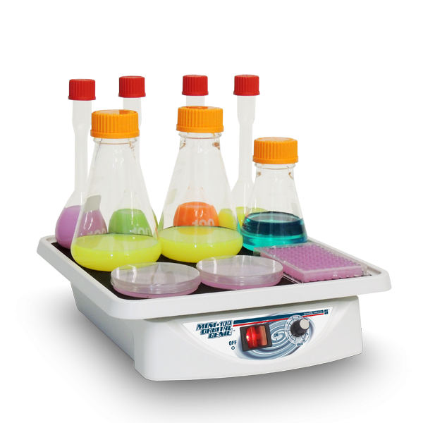 Laboratory hot plate with beakers containing colorful liquids on a white background