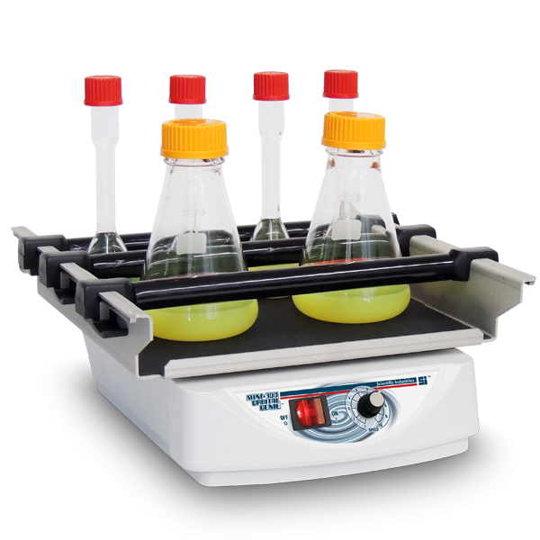 Laboratory hot plate with four bottles on a white background
