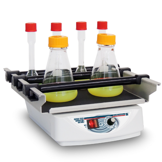 Laboratory hot plate with four bottles on a white background