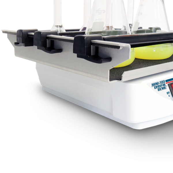 Close-up of a tennis ball holder with a tennis ball inside, on a white background.